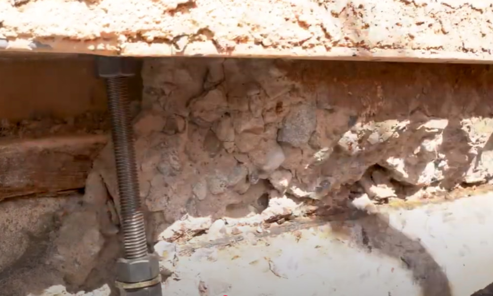Anchor bolts installed in concrete foundation to meet building code requirements